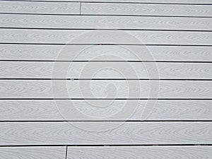 Grey artificial or composite wood boards on deck with lines