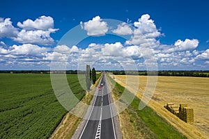 Grey asphalted narrow country road aerial view