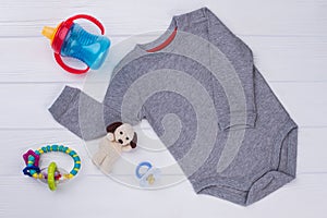 Grey baby onesie and toys
