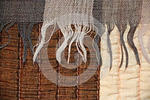 Grey background with textile textures and  rounded shapes