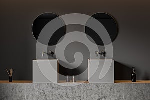 Grey bathroom interior with sink and mirror, accessories on deck