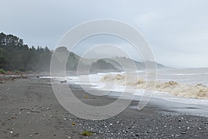 Grey beach with ground swell on the eastern shores of New Zealand near Kekerengu