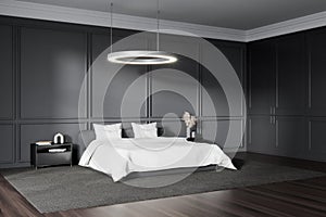 Grey bedroom interior with bed, nightstand and decoration