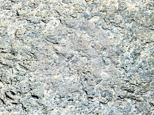 Grey beige stone wall background texture. Rocky formation with holes. Greek island Cyclades Greece