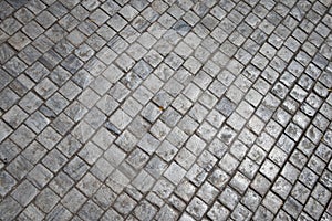 Grey brick stone street road. Pavement texture