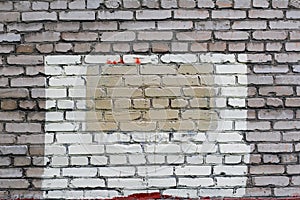 Grey brick wall with painted splotch