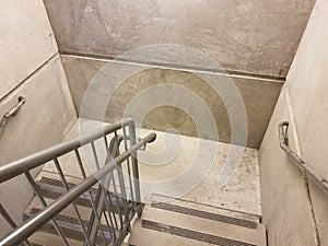 Grey cement stairs or steps and metal railing