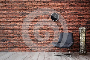 Grey chair and lamp near  wall. Modern room interior