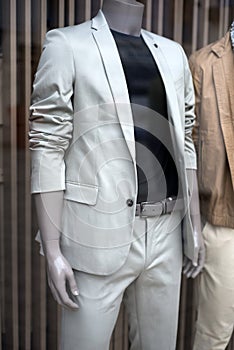 grey classic suit for men on manequin in a fashion store showroom