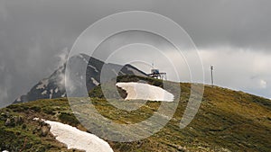 Grey clouds passing at mountain peak, timelaps