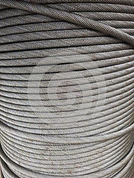 Grey coil of steel metal rope, spiral pattern