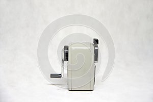 Grey color of pencil sharpener isolated on white fabric background.