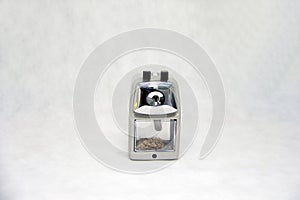 Grey color of pencil sharpener isolated on white fabric background.