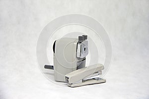 Grey color of pencil sharpener and Stapler isolated on white fabric background.