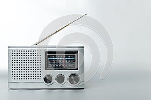 Grey colored retro radio on the silver background.Empty space for text
