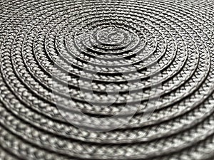 Grey colour background. Circular wicker grey colour texture.