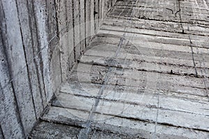 Grey concrete wall with hardened traces of the shuttering moulds