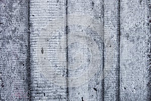 Grey concrete wall with hardened traces of the shuttering moulds