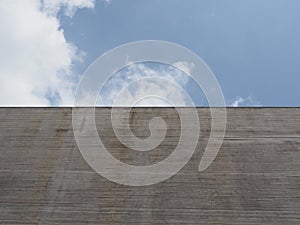 grey concrete wall over blue sky background