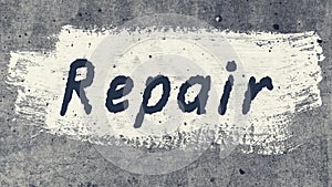 Grey concrete wall with the text on the white paint repair