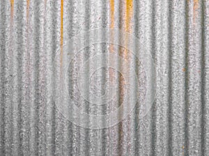 grey corrugated steel with rust leak