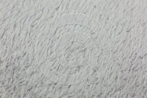 Grey cotton towel or carpet.fluffy texture background. Close up, macro photo. Soft focus image