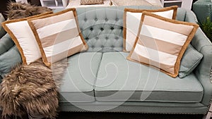 Tan and white cushions on a sofa as styled by interior designer