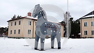 Grey Dalarna horse in front of Rattvik townhall in winter in Sweden