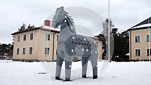 Grey Dalarna horse in front of Rattvik townhall in winter in Sweden photo