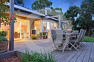 Grey deck and lit house.