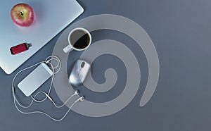 Grey desktop with mobile devices and coffee drink in flat lay format for telework or telecommute concept