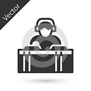 Grey DJ wearing headphones in front of record decks icon isolated on white background. DJ playing music. Vector