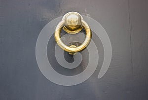 Grey door with a gold doorknocker