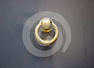 Grey door with a gold doorknocker