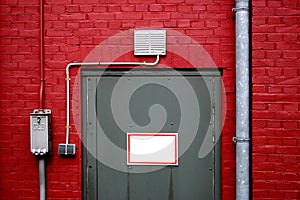 Grey door on red wall