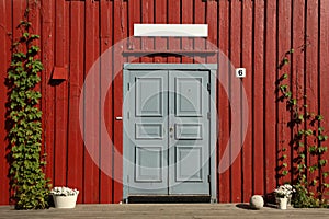Grey door with red wooden wall