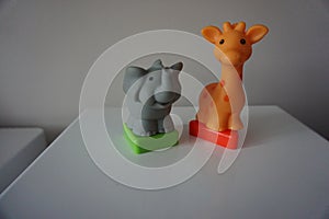 Grey elephant and orange giraffe. Plastic figures