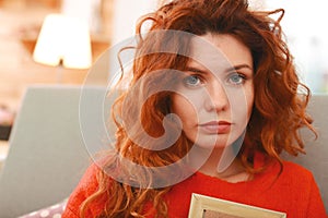 Grey-eyed woman with foxy hair feeling brokenhearted photo