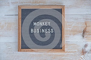 grey felt Board with English text monkey business