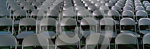 Grey folding chairs awaiting the crowd