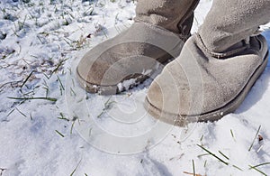 Grey fuzzy boots in the winter snow