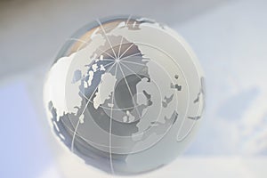 Grey glass world globe, round shaped earth miniature with continents