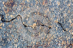 Grey granite slab with a deep crack close-up. Natural stone texture