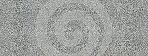 Grey Granular Surface or background. Granularity showcased in varying shades of gray and white colors. Panorama with photo