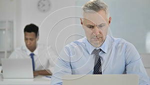 Grey Hair Businessman Working on Laptop in Office