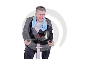 Grey hair man doing exercise with bike stationary