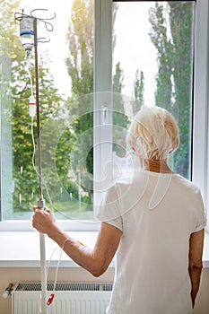 Grey haired delicate woman hoping getting better soon