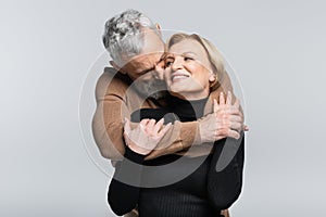 Grey haired man kissing and hugging
