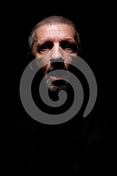 Grey haired man with opened mouth and scaring look