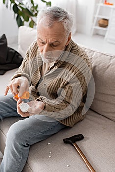 grey haired man suffering from parkinsonism